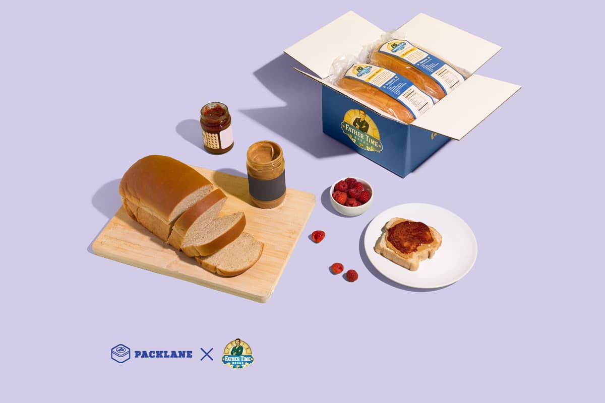Father Time Bread case study showing bread on a cutting board with peanut butter, jam, a bowl of strawberries, and a custom mailer box